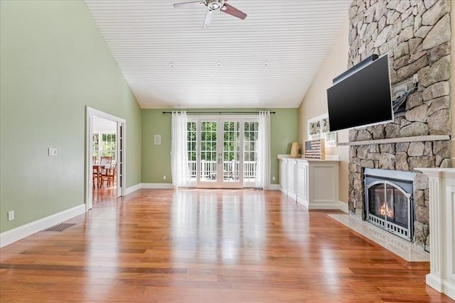 138 Saddleworth Way, Middleboro, MA 02346 - unfurnished living room with a stone fireplace, ceiling fan, wood finished floors, high vaulted ceiling, and baseboards