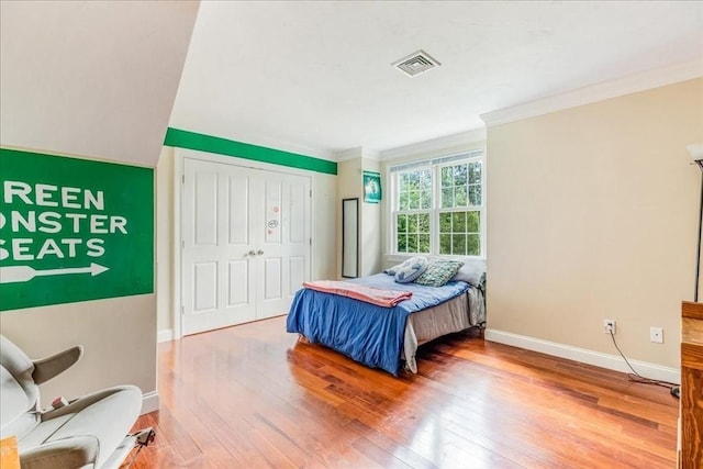 138 Saddleworth Way, Middleboro, MA 02346 - bedroom with wood-type flooring, ornamental molding, baseboards, and a closet