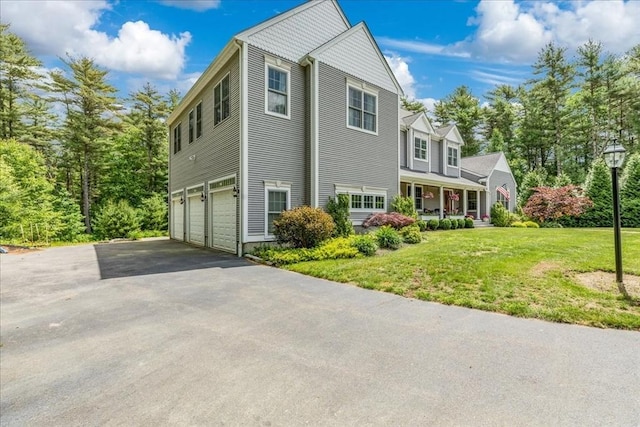 138 Saddleworth Way, Middleboro, MA 02346 - view of home's exterior featuring a garage, asphalt driveway, a yard, and a porch