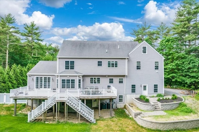 138 Saddleworth Way, Middleboro, MA 02346 - back of property featuring stairway, a wooden deck, and a lawn