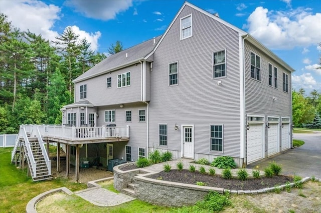 138 Saddleworth Way, Middleboro, MA 02346 - rear view of property featuring a wooden deck, a garage, driveway, and stairway