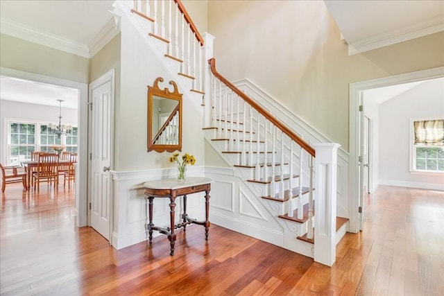 138 Saddleworth Way, Middleboro, MA 02346 - stairway with wood finished floors, a chandelier, and ornamental molding