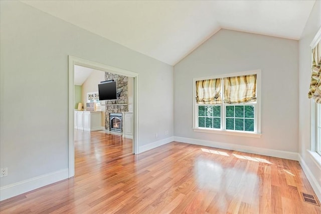 138 Saddleworth Way, Middleboro, MA 02346 - spare room with lofted ceiling, plenty of natural light, light wood-style floors, and a fireplace