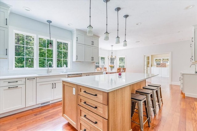 138 Saddleworth Way, Middleboro, MA 02346 - kitchen with a sink, light countertops, a kitchen breakfast bar, light wood-style flooring, and recessed lighting