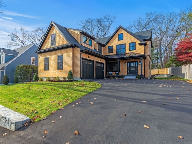 view of front of house with a garage and a front lawn