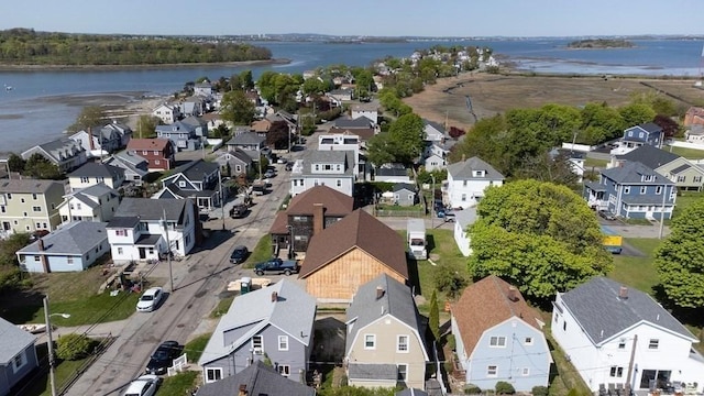 drone / aerial view featuring a water view and a residential view
