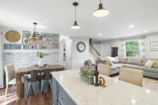 22 Dean St, Hudson, MA 01749 - kitchen featuring wainscoting, dark wood-type flooring, light stone counters, decorative light fixtures, and gray cabinets