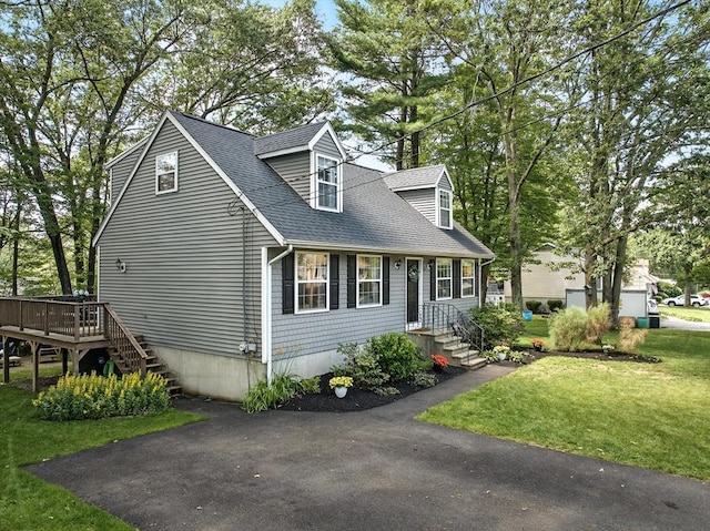 22 Dean St, Hudson, MA 01749 - new england style home featuring a shingled roof, a front yard, and a deck