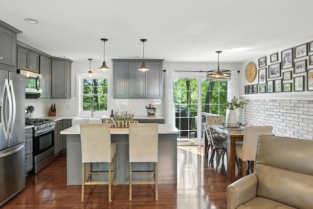 22 Dean St, Hudson, MA 01749 - kitchen with stainless steel appliances, plenty of natural light, light countertops, and backsplash