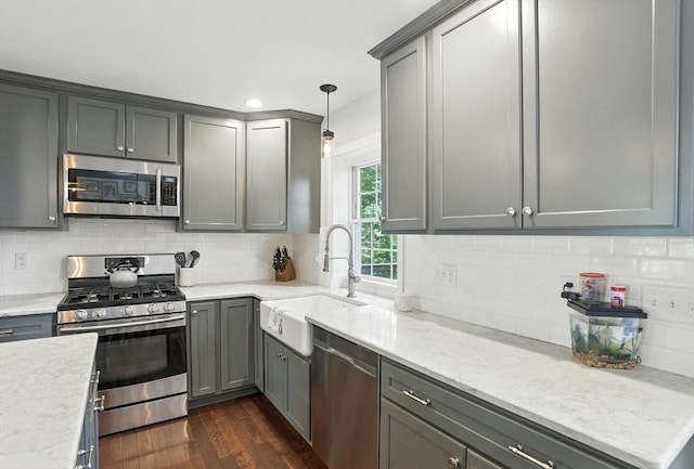 22 Dean St, Hudson, MA 01749 - kitchen with stainless steel appliances, gray cabinets, dark wood-style floors, tasteful backsplash, and pendant lighting