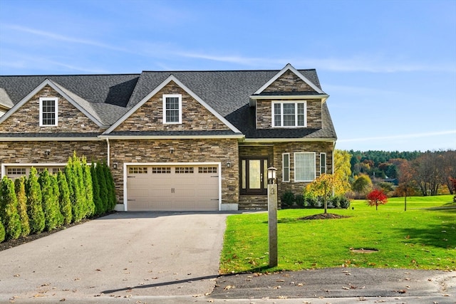 craftsman-style home with a front yard and a garage