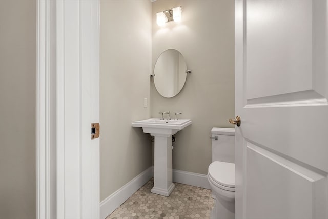 bathroom featuring toilet and tile patterned flooring