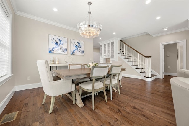 dining space featuring ornamental molding, a notable chandelier, and dark hardwood / wood-style floors