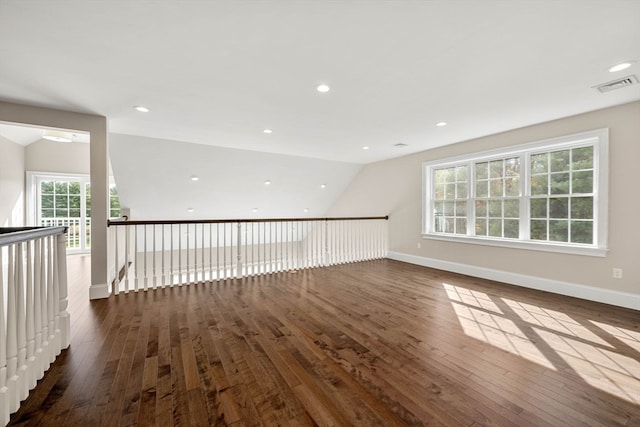 additional living space featuring lofted ceiling and dark hardwood / wood-style floors