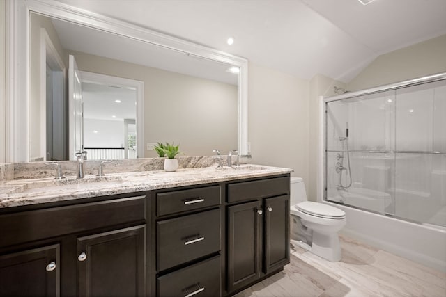 full bathroom with vanity, toilet, lofted ceiling, and enclosed tub / shower combo