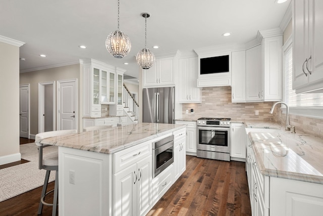 kitchen with a center island, white cabinets, stainless steel appliances, and dark wood-type flooring