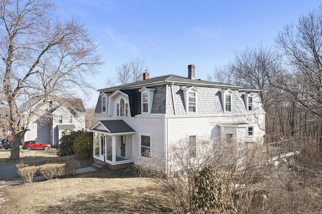 33 Burbank St, Millbury, MA 01527 - view of side of home featuring a chimney and mansard roof