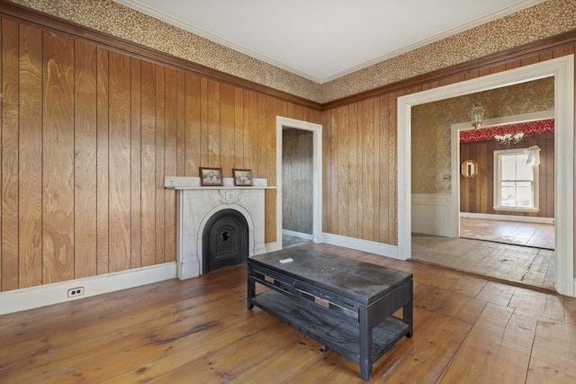 33 Burbank St, Millbury, MA 01527 - unfurnished living room featuring hardwood / wood-style flooring, crown molding, a fireplace, and baseboards