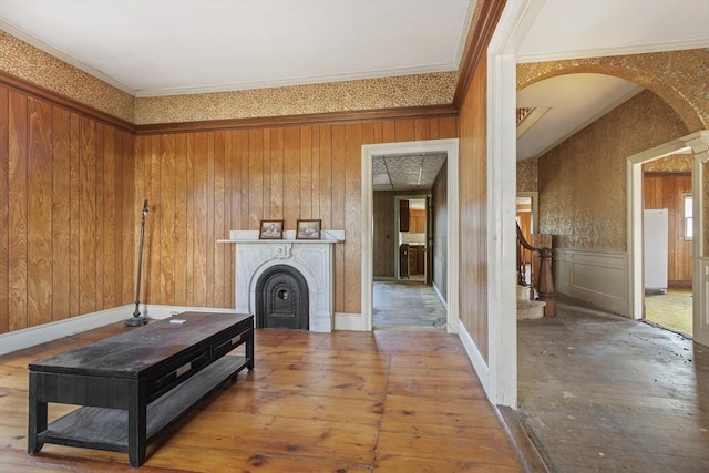 33 Burbank St, Millbury, MA 01527 - living room featuring arched walkways, a fireplace, stairway, ornamental molding, and hardwood / wood-style floors