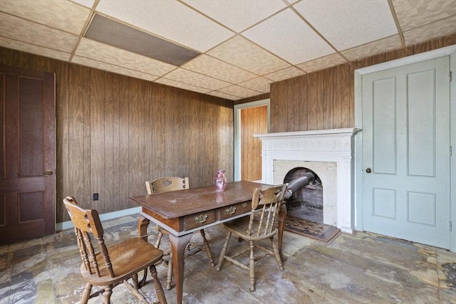 33 Burbank St, Millbury, MA 01527 - dining space with wood walls, a drop ceiling, and a fireplace with raised hearth