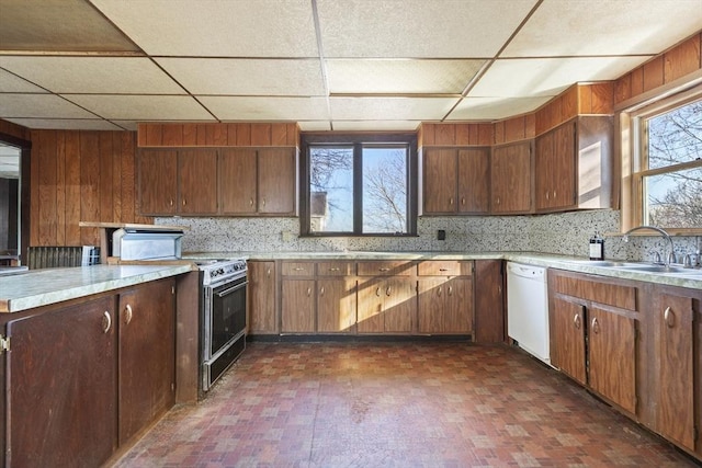 33 Burbank St, Millbury, MA 01527 - kitchen featuring white dishwasher, electric range, a sink, brick patterned flooring, and a paneled ceiling