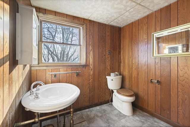 33 Burbank St, Millbury, MA 01527 - bathroom featuring toilet, wooden walls, a sink, and baseboards