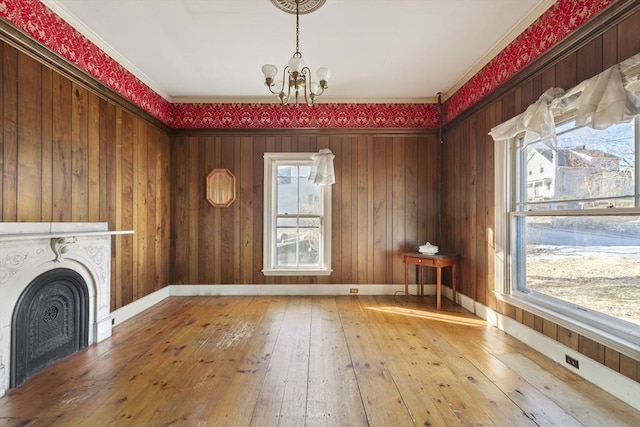 33 Burbank St, Millbury, MA 01527 - unfurnished dining area featuring a chandelier, hardwood / wood-style floors, crown molding, a fireplace, and baseboards