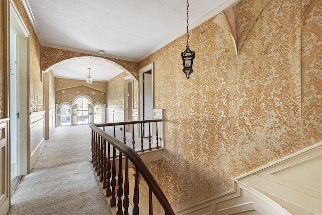 33 Burbank St, Millbury, MA 01527 - hall featuring wallpapered walls, arched walkways, a decorative wall, carpet floors, and an upstairs landing