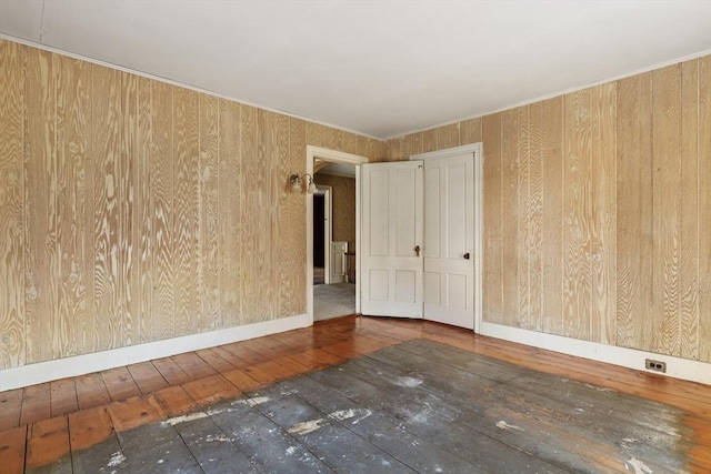 33 Burbank St, Millbury, MA 01527 - spare room featuring hardwood / wood-style floors, wood walls, and baseboards
