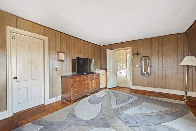 33 Burbank St, Millbury, MA 01527 - bedroom with wood-type flooring, wood walls, and baseboards
