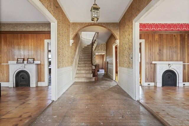 33 Burbank St, Millbury, MA 01527 - entrance foyer featuring a fireplace, hardwood / wood-style floors, wallpapered walls, stairway, and wainscoting