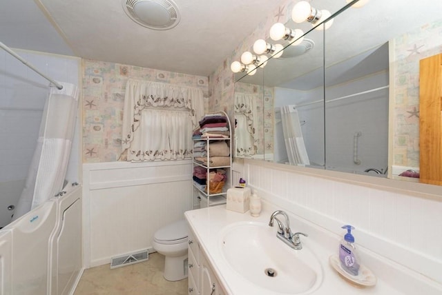 bathroom with vanity, toilet, and walk in shower