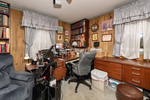 office space featuring ceiling fan, light colored carpet, and wooden walls