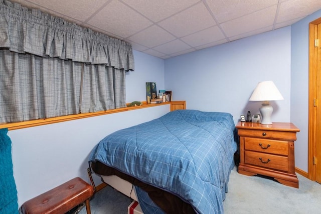 carpeted bedroom featuring a paneled ceiling