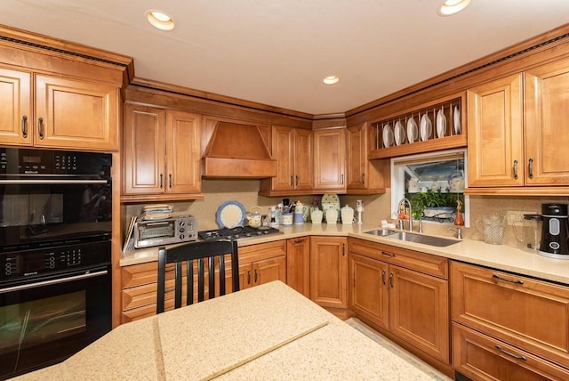 kitchen with double oven, custom exhaust hood, sink, and stainless steel gas stovetop