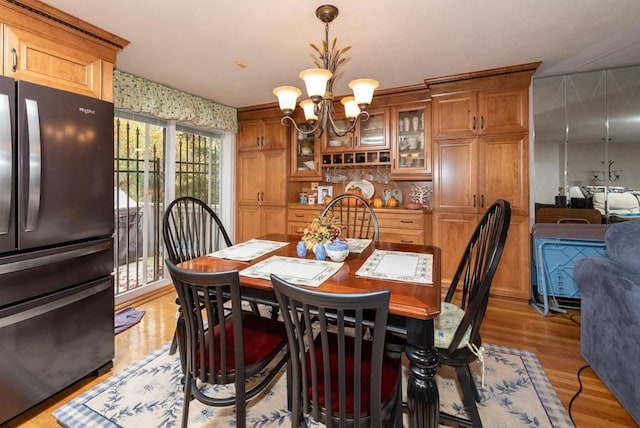 dining area featuring a chandelier and light hardwood / wood-style floors