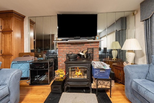 living room featuring a wood stove and light wood-type flooring