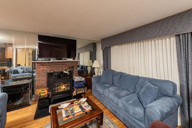 living room featuring light hardwood / wood-style floors and a wood stove