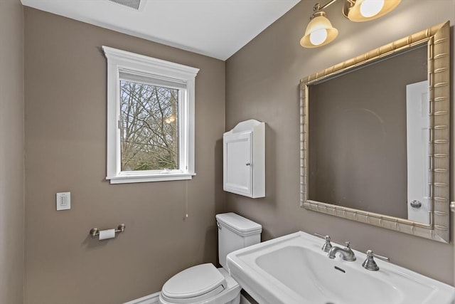 bathroom with toilet and a sink