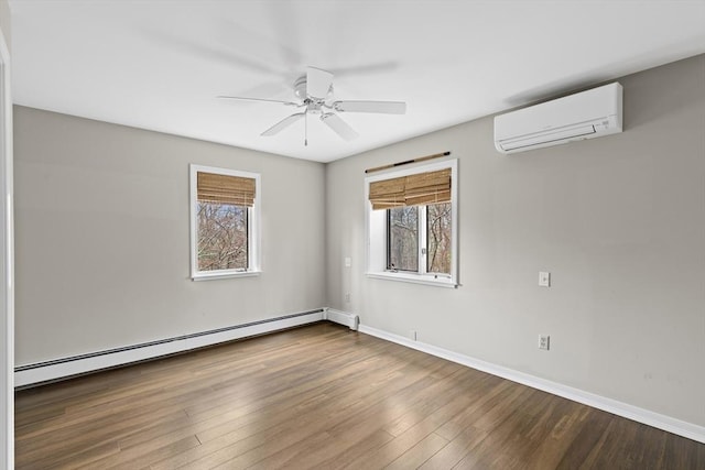 unfurnished room with baseboards, wood finished floors, a ceiling fan, a baseboard heating unit, and a wall unit AC