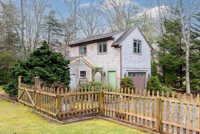 rear view of house with a garage, fence, and a shingled roof