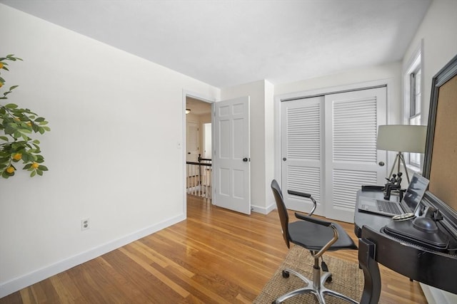 office area featuring baseboards and light wood-style floors