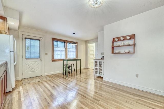 interior space with light wood-style flooring and baseboards