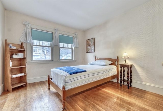 bedroom featuring baseboards and hardwood / wood-style floors