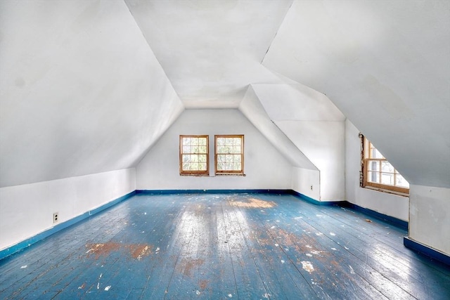 bonus room featuring hardwood / wood-style flooring, baseboards, and vaulted ceiling