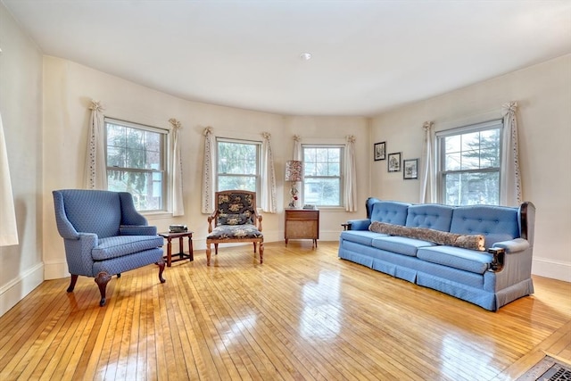 living room featuring light wood-type flooring and baseboards