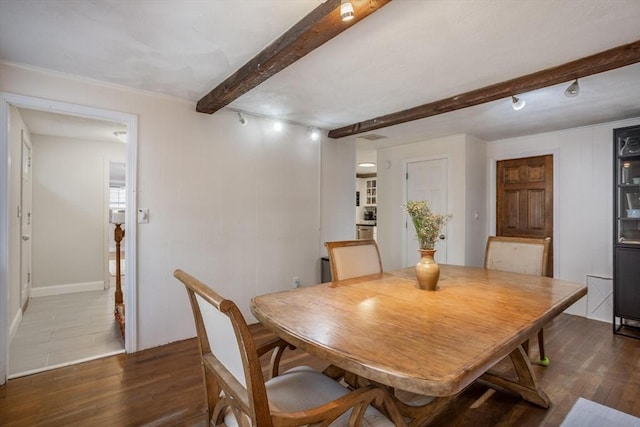 dining space with dark wood-type flooring and beam ceiling