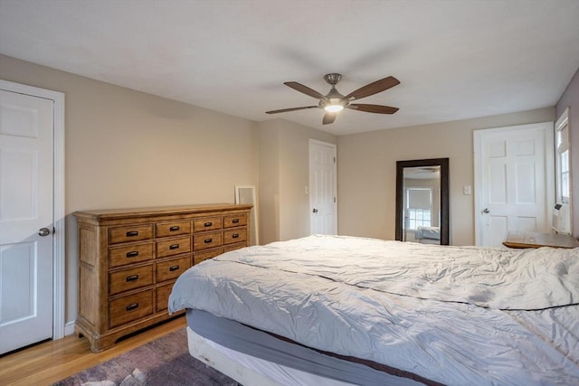 bedroom featuring a ceiling fan and light wood-type flooring