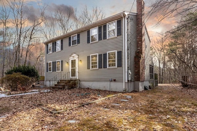 colonial inspired home featuring a chimney