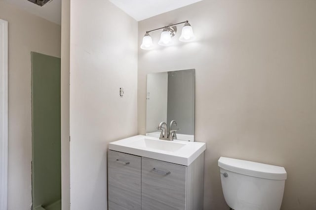 bathroom featuring toilet and vanity